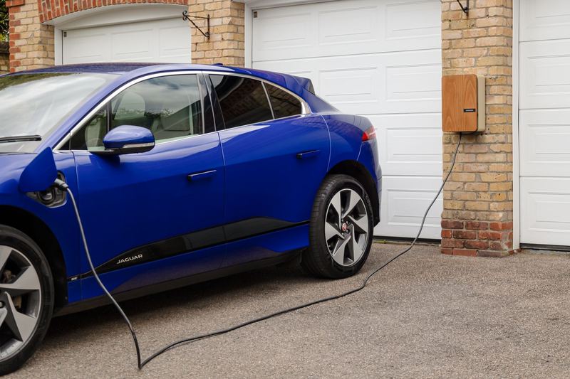 Electric car charging from a wall-mounted Level 2 charger at home